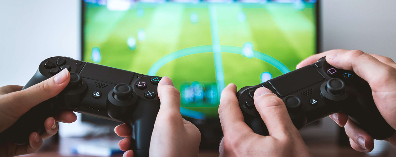 image of Hands holding console game